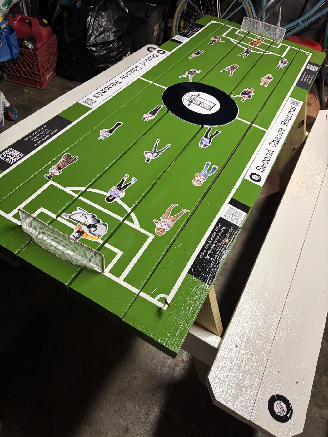 Hand-painted Cherry Bombs FC sponsor table with iconic female musicians as players